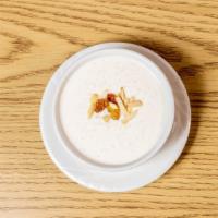 Kheer · Rice pudding garnished with nuts and raisins.