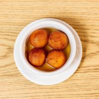 Gulab Jamun · A warm delectable sweet made from milk and honey served in thick sugary syrup.