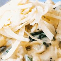 Fettuccine Alfredo · Our delicious cream sauce with spinach & mushrooms topped with parmesan cheese
