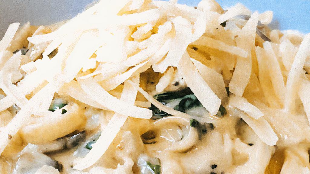Fettuccine Alfredo · Our delicious cream sauce with spinach & mushrooms topped with parmesan cheese