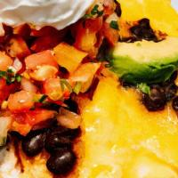 Huevos Rancheros · Two eggs over medium, topped with cheddar cheese, avocado, black beans, salsa & sour cream o...