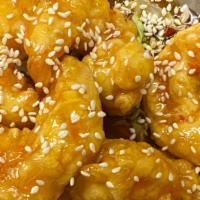 Sesame Prawns · Pan-tossed lightly battered prawns in a spicy sesame sauce, topped with sesame seeds.