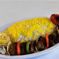 Shish Kabob · Tender beef filet mignon, marinated and grilled on a skewer, served with grilled tomato, oni...