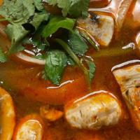 Tom Yum Soup · Hot and sour soup with lemongrass, mushrooms, tomato, onion, green onion and kaffir lime lea...