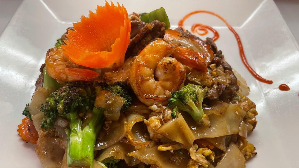 Pad See Ew · Flat big rice noodle stir fried with, egg, broccoli, cabbage and carrot in black soy sauce.