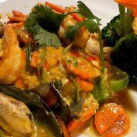 Seafood Pad Curry · Shrimp, squid, mussel and scallop stir fried with curry, onion, bell pepper, egg, milk and c...