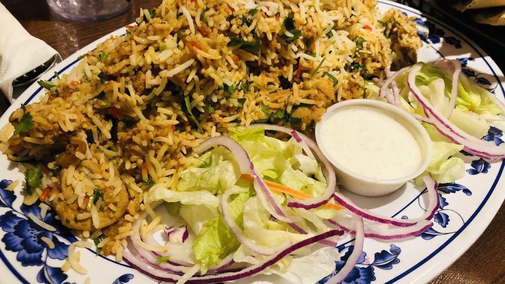 Chicken Biryani · Basmati rice with boneless chicken cooked in herbs, spices and seasonings.