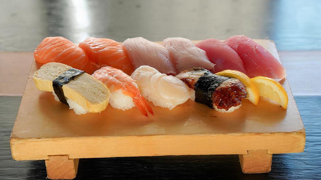 Nigiri Set · 10 pieces. Salmon 2 pieces, tuna 2 pieces, hamachi 2 pieces, tamago 1 piece, ebi 1 piece, hotate 1 piece, eel 1 piece
