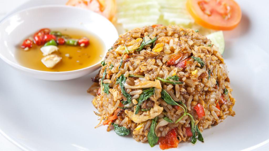 Basil Fried Rice · Fresh fried rice with holy basil, red bell peppers, onions, green beans, fish sauce, and bok choy. Served with a fried egg on top.