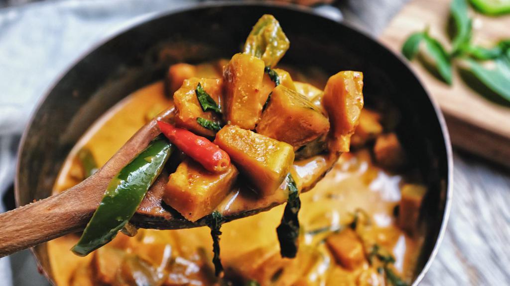 Kabocha Squash Curry · Kabocha squash in a red curry sauce with red bell peppers, carrots, and Thai basil. Comes with Jasmine Rice.