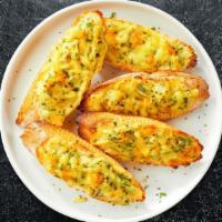 Cheese Bread · Organic garlic bread topped with Mozzarella and Parmesan cheese. Served with our home made M...