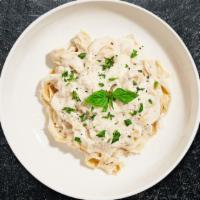 Fettuccine Alfredo · Fettuccine tossed in homemade classic Alfredo sauce with roasted red peppers, topped with Pa...