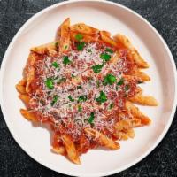 Penne Puttanesca · Penne tossed with tomato and basil sauce topped with Kalamata olives, capers, Parmesan and f...