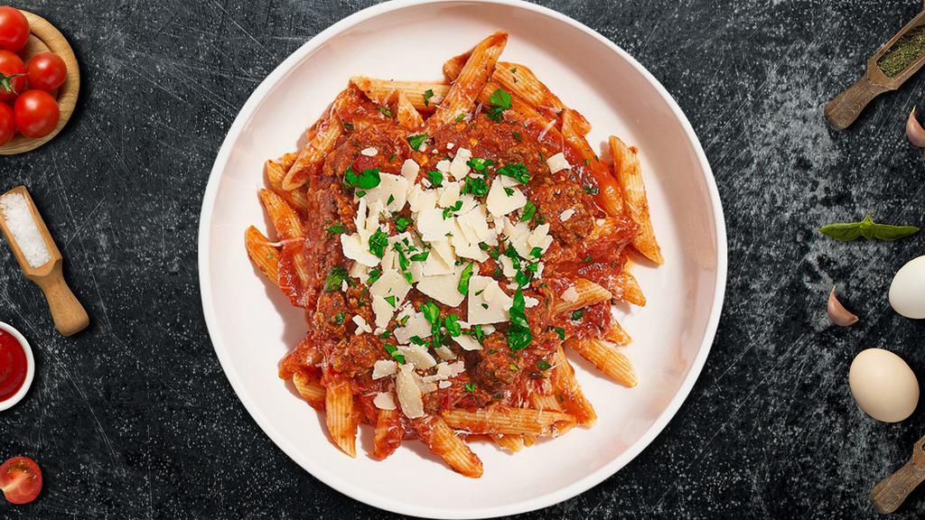Spicy Penne With Sausage · Penne pasta with homemade pork sausage, sauteed onions, a touch of chili flakes, in a tomato cream sauce.