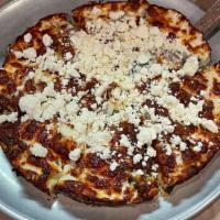 Greek Pizza · Spinach feta cheese, mozzarella cheese, onions, beef gyro meat, and tomato sauce.