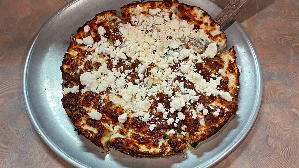 Greek Pizza · Spinach feta cheese, mozzarella cheese, onions, beef gyro meat, and tomato sauce.
