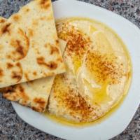 Small Hummus · Topped with olive oil and paprika and served with a half pita.