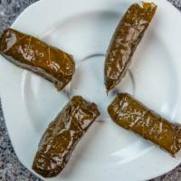 Large Dolmades (Stuffed Grape Leaves) · Grape leaves stuffed with rice and spices, it comes in 8 pieces