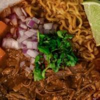 Birria Ramen · Ramen noodles in consome topped with birria, cilantro, onions, pickled carrots, and lime.
