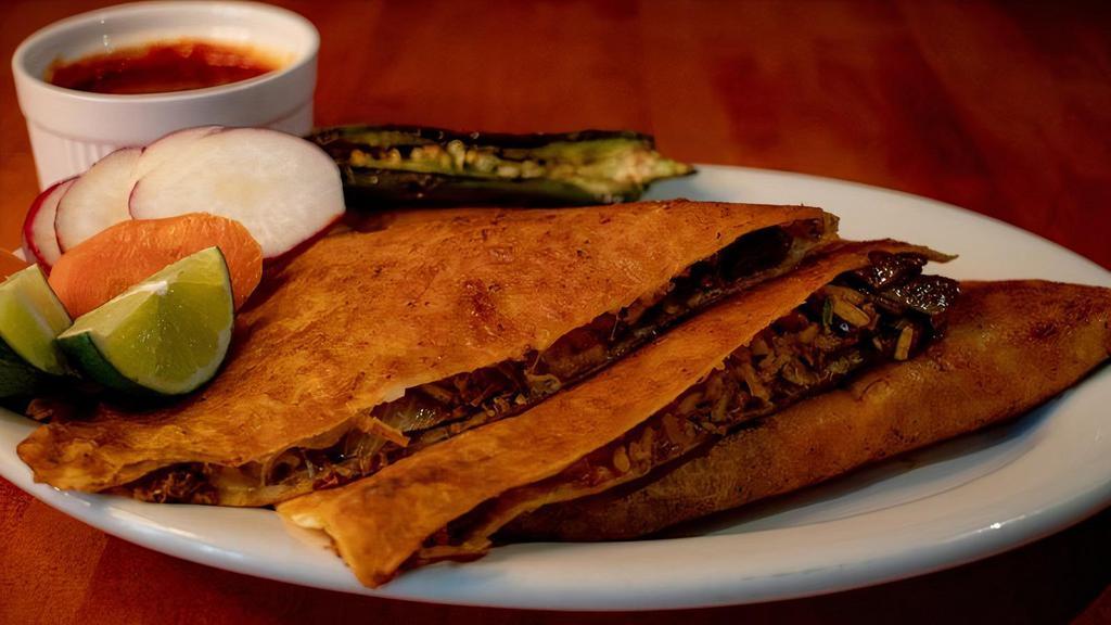 Quesadilla · Flour tortilla, cheese, onions, cilantro, birria meat. Served with consome, radishes and limes.
