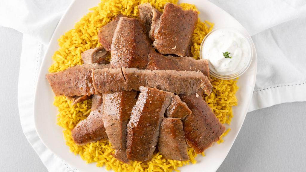 Lamb Gyro Platter · Tender slices of hand carved lamb gyro meat, served over a bed of rice, pick a side and sauce to complete the meal.