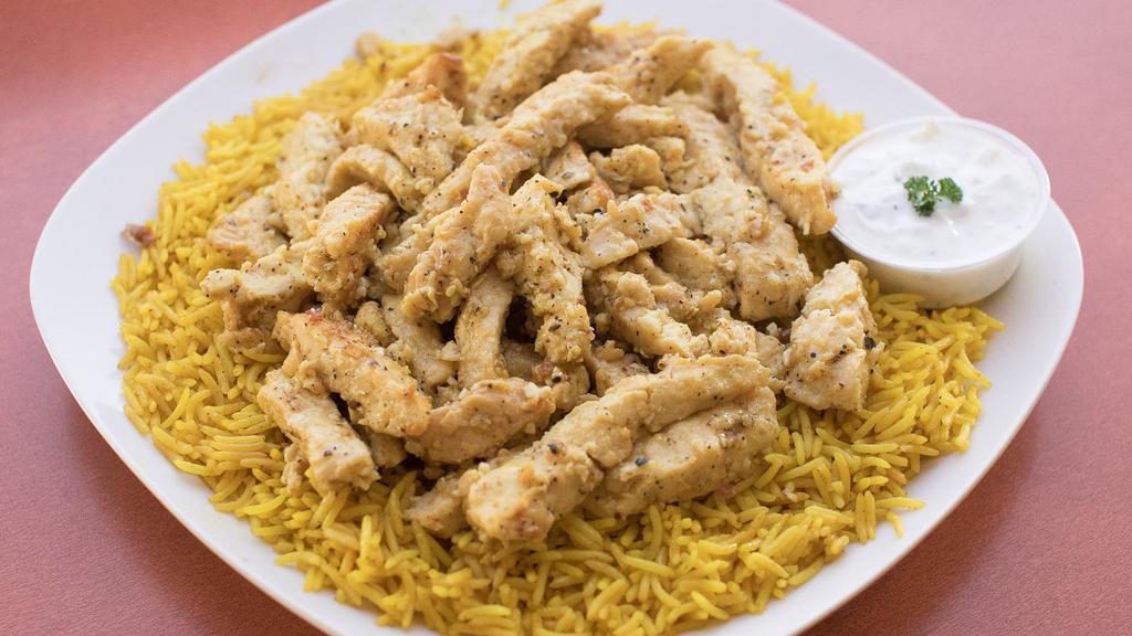 Chicken Shawarma Platter · Sliced chicken breast sauteed in shawarma spices (not spicy). Served over a bed of rice, pick a side and sauce to complete the meal.