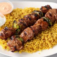 Lamb Kebob Platter · Two skewers of grilled marinated boneless lamb pieces. Served over a bed of rice, pick a sid...