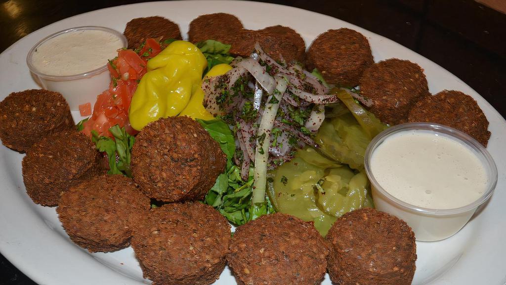 Falafel Platter · Spiced chickpea patties deep fried. Served over a bed of basmati rice and with side sauce.