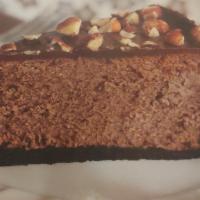Nutella Cheesecake Slice · Slice of Nutella Cheesecake topped with crushed hazelnuts