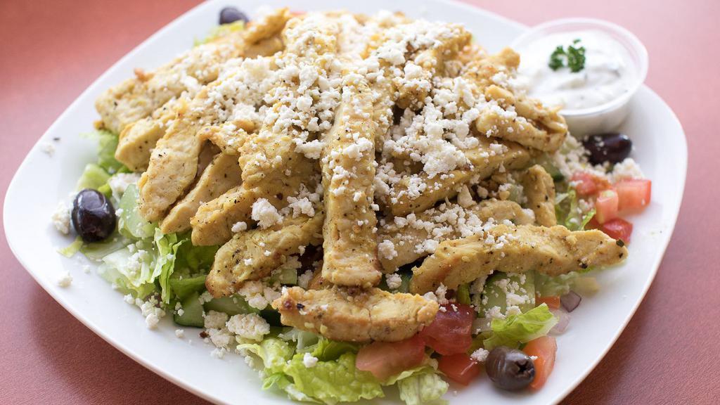 Chicken Shawarma Salad · Chicken breast slices sautéed in our special shawarma spices. Served over a Greek salad and comes with a side of tzatziki sauce.