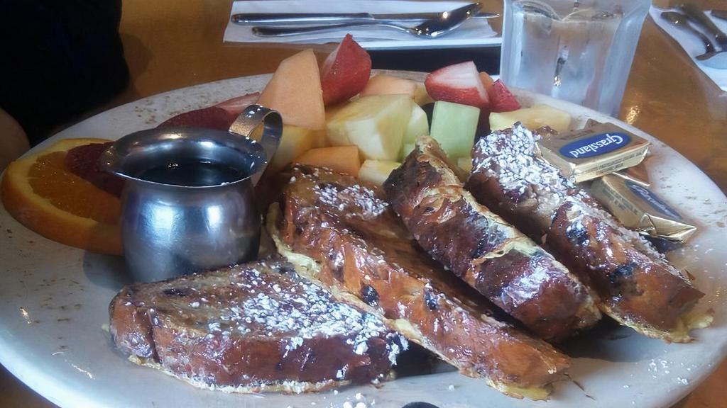 French Toast · Delicious raisin bread, or whole wheat hazelnut currant bread, coated And sautéed to perfection, dusted with powdered sugar. Served with butter And real maple syrup.