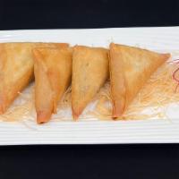 Samosas · Curry puffed filled with potato, onion, turmeric and pepper.