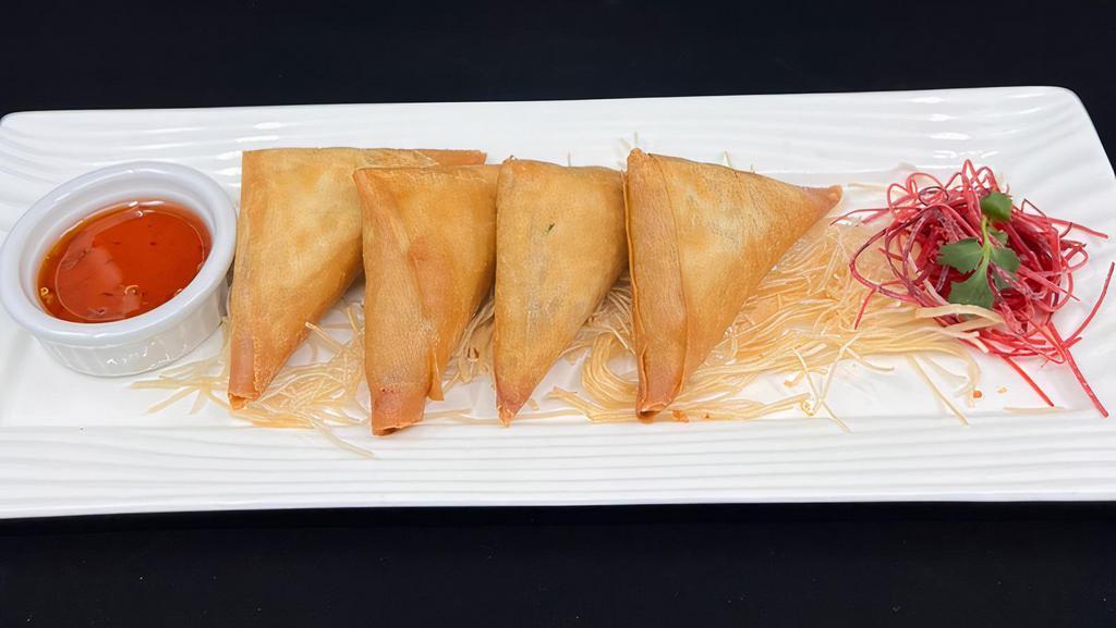 Samosas · Curry puffed filled with potato, onion, turmeric and pepper.