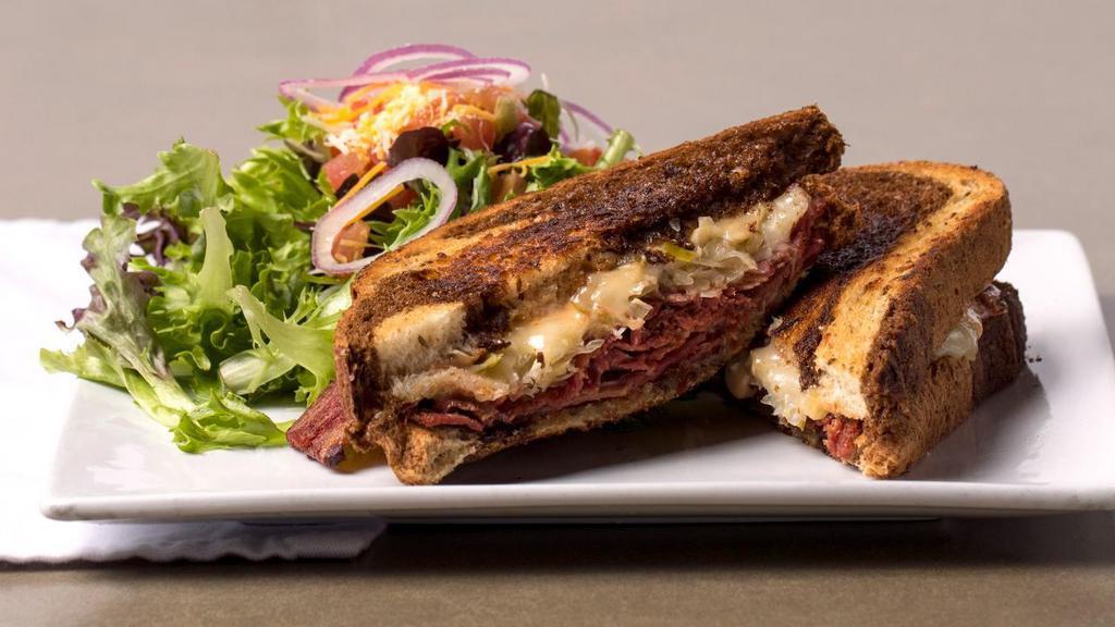 Reuben · Grilled corned beef brisket, gruyère cheese, sauerkraut with 1000 island dressing on toasted rye. Served with your choice of side.