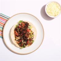 Al Pastor Taco Taco · Marinated pork, pineapple, pico de gallo, and salsa on a corn tortilla.
