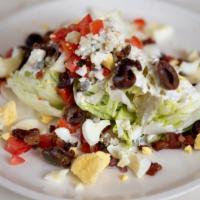 Classic Wedge Salad · Iceberg, smoked bacon, tomato, egg crumbles, kalamata olives, and roquefort.