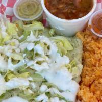 #7 Enchiladas De Pollo Combo · Three enchiladas verdes with shredded lettuce, sour cream and  a side of rice and refried be...