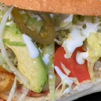 Torta Cubana · Local telera bread with your choice of meat, sliced hot dog, tomato, lettuce, jalapenos, pic...