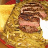Beef Stroganoff · An eight-ounce iron steak cooked to order on top of a pile of fettuccini noodles with sautée...