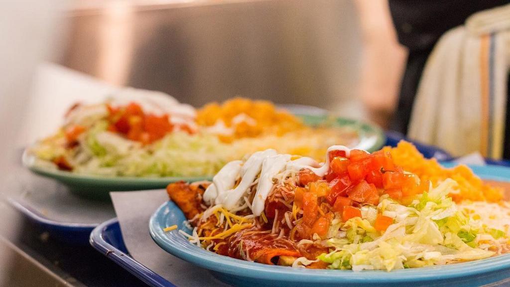 Enchilada Plate · 3 Enchiladas. Served with Mexican refried beans, rice, lettuce, tomatoes, sour cream and cheese.