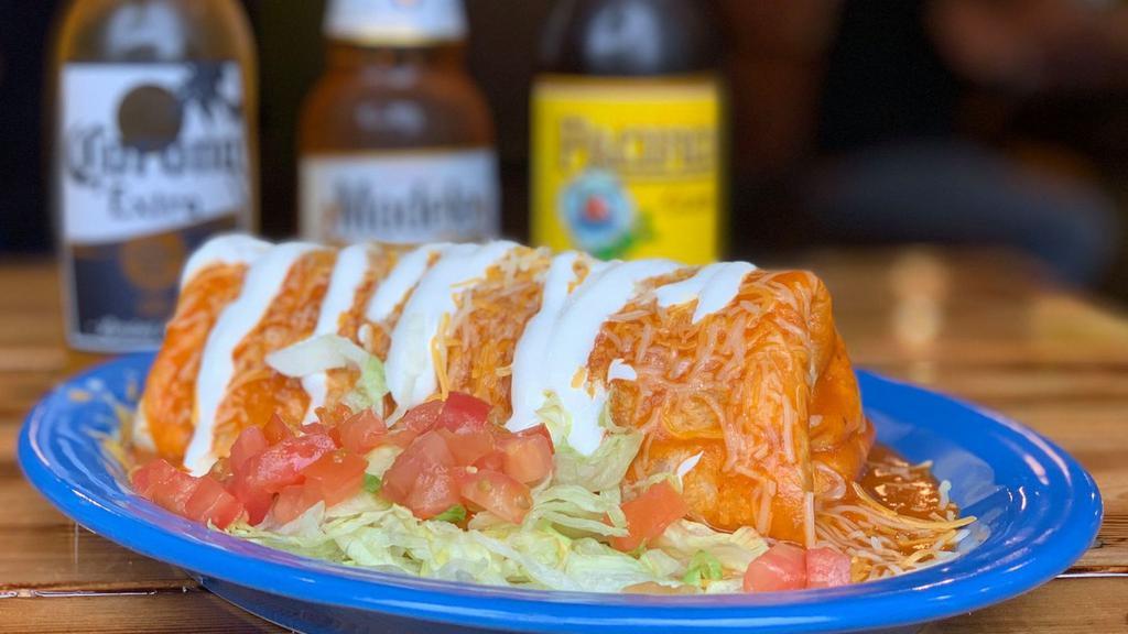 Chile Relleno Burrito · California chile stuffed with Monterey Jack cheese and dipped in our batter with Mexican refried beans, rice, Pico De Gallo, and green chile.