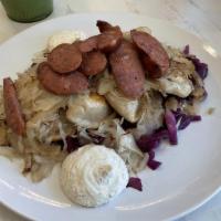 Polish Pierogi · Potato & Cheese pierogi topped with kielbasa, sauerkraut, caramelized onion and mustard sour...