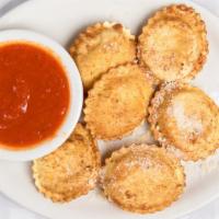 Fried Ravioli · Cheese ravioli, breaded and deep-fried to a golden brown and served with a side of marinara ...