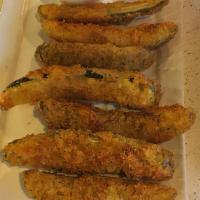 Fried Pickles · House breaded pickle spears served with ranch .