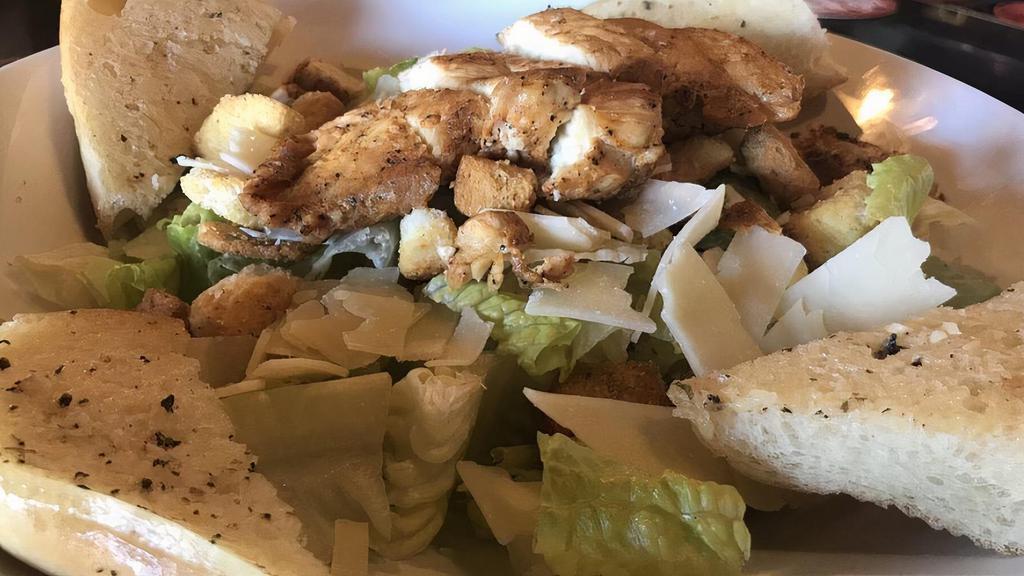 Sesame Chicken Salad · Strips of chicken breast tossed with romaine, tomatoes, red onions, olives, croutons, three cheeses and mushrooms. Toasted sesame seed dressing on the side and served with garlic bread.