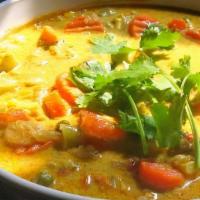 Vegetable Coconut Curry (V) · Vegetables cooked with onions, tomatoes, coconut milk, and spices. Served with rice.