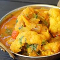 Aloo Gobi Masala (V) · Vegetarian. 
Cauliflower and cubes of potatoes cooked with mildly spiced garlic and ginger s...