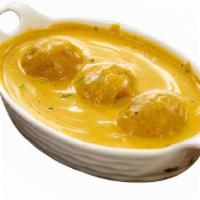 Malai Kofta · Cheese balls in a creamy, mildly spicy gravy, sprinkled with nuts and raisins. Served with r...