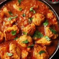 Chicken Curry · Boneless chicken, onions, garlic, ginger, tomatoes, and curry spices. Served with rice.