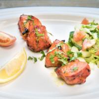 Chicken Tikka · Boneless chicken, marinated in yogurt, and mild spices, cooked in the tandoor. Served with r...